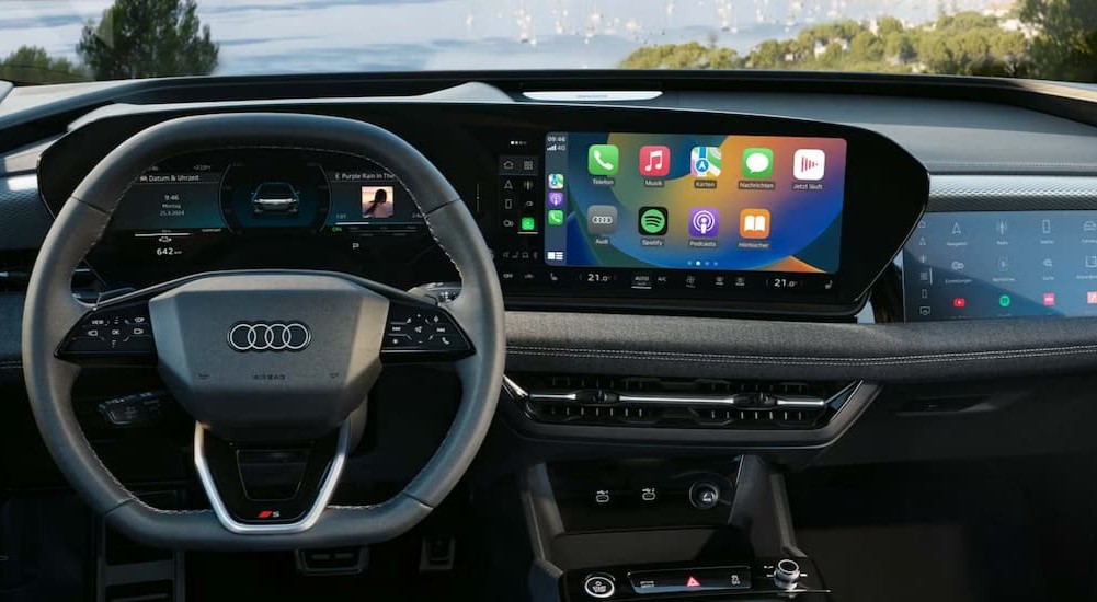 The black dashboard is shown in a 2026 Audi A6 Sportback e-tron.