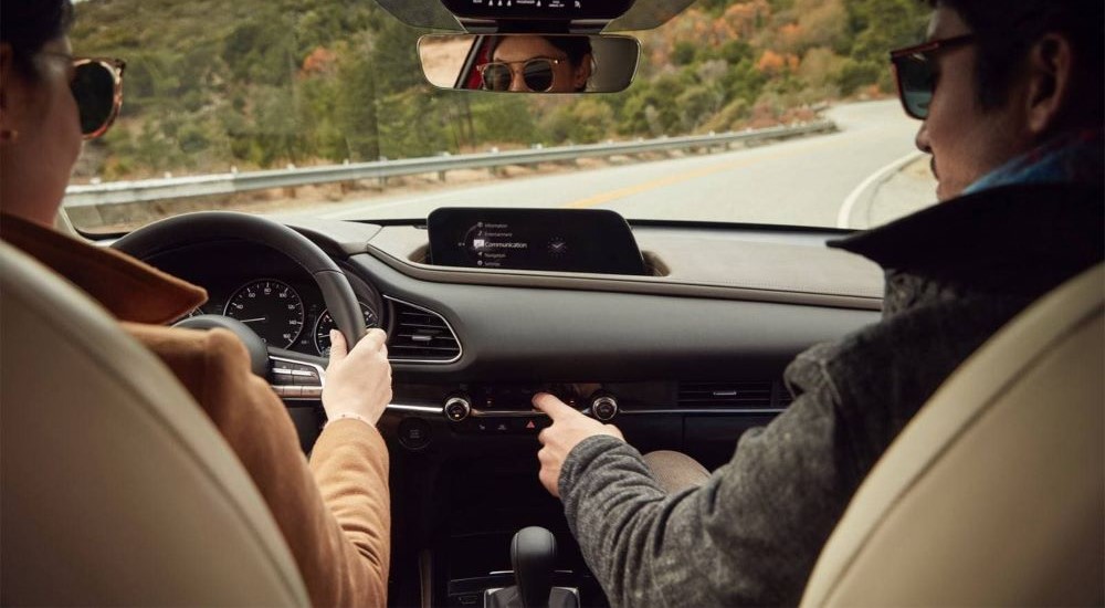 Two people in the interior of a 2025 Mazda CX-30.