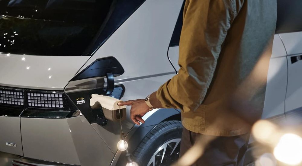 A white 2023 Hyundai IONIQ 5 plugged in charging