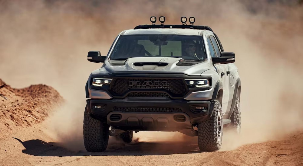 A silver 2024 Ram 1500 TRX off-roading after viewing a used Ram for sale.