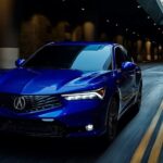 A blue 2025 Acura Integra hatchback driving in a tunnel.