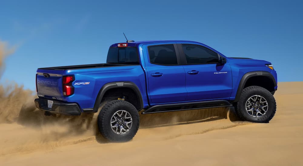 Blue 2025 Chevy Colorado ZR2 off-roading on sand