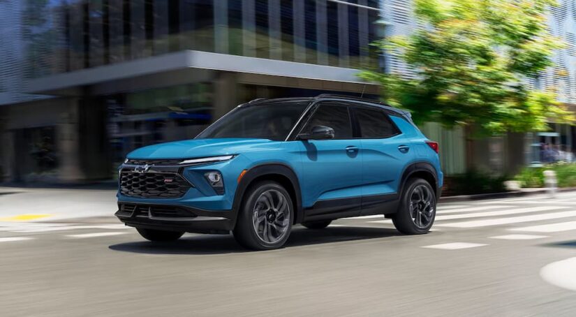 Blue 2025 Chevy Trailblazer RS driving down a city street