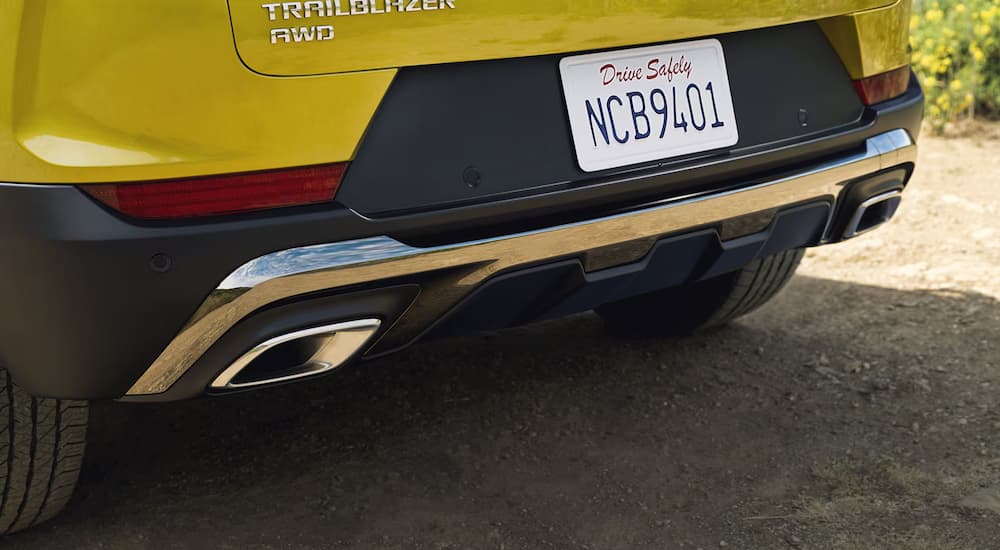Yellow 2025 Chevy Trailblazer rear exterior on a dirt road
