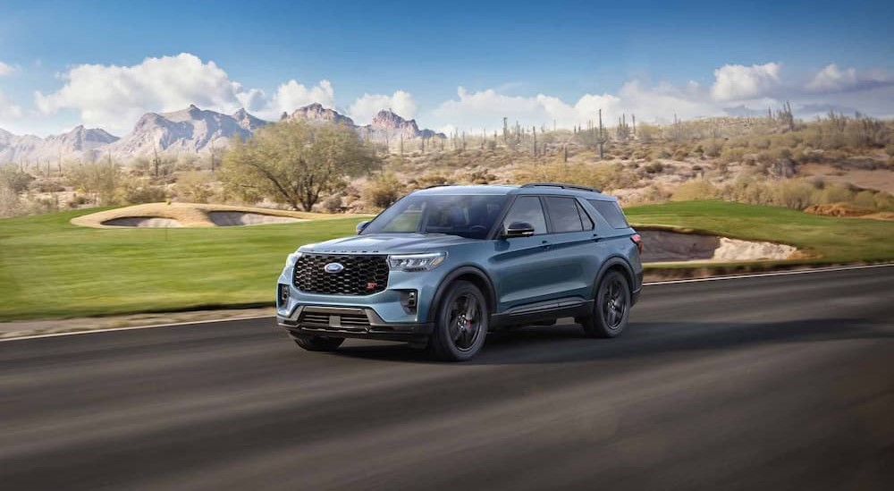 A blue 2025 Ford Explorer ST driving on a sunny day.