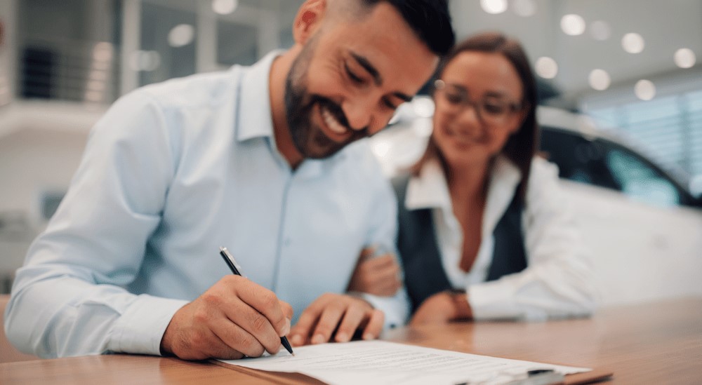 A person signing a document.