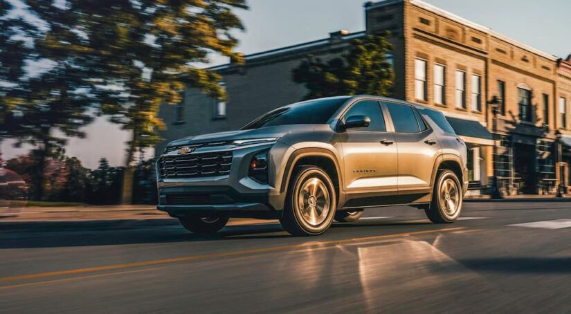 Grey 2026 Chevy Equinox LT driving downtown.