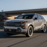 Gray 2025 Kia Sportage driving on highway
