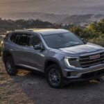A gray 2025 GMC Acadia parked off-road