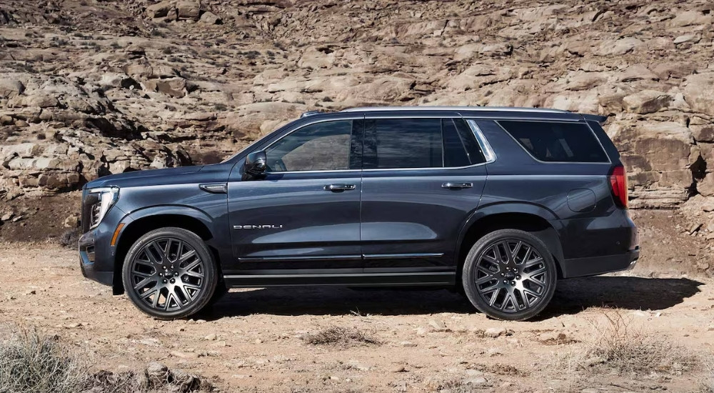 A dark gray 2025 GMC Yukon Denali parked off-road
