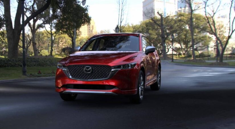 A red 2025 Mazda CX-5 parked in a city