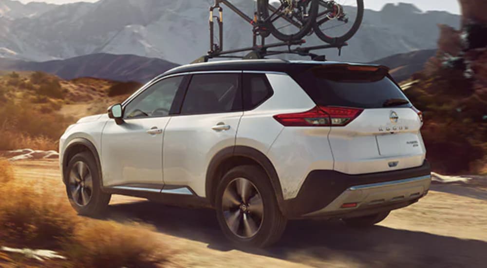 A white 2021 Nissan Rogue off-roading
