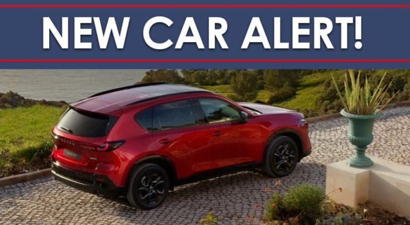 A "New Car Alert" banner above a red 2026 Mazda CX-5.