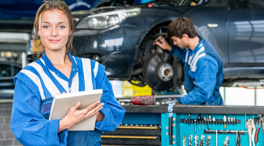 Two technicians working in a garage.