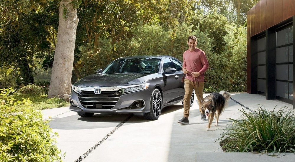 A gray 2021 Honda Accord Hybrid parked on a driveway.