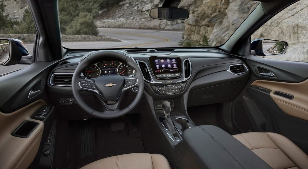 The black and tan interior and dash in a 2023 Chevy Equinox.
