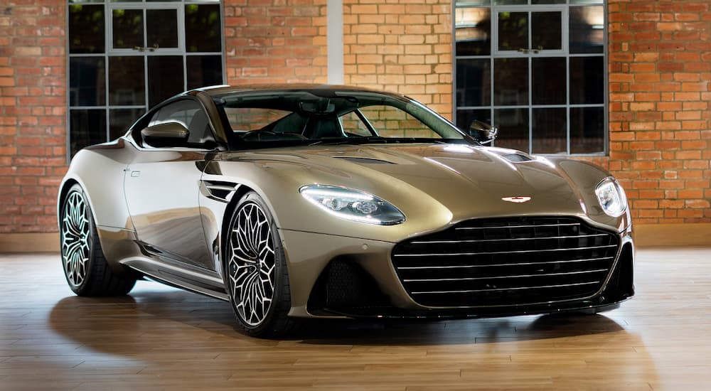 A tan 2020 Aston Martin DBS Superleggera parked in a showroom