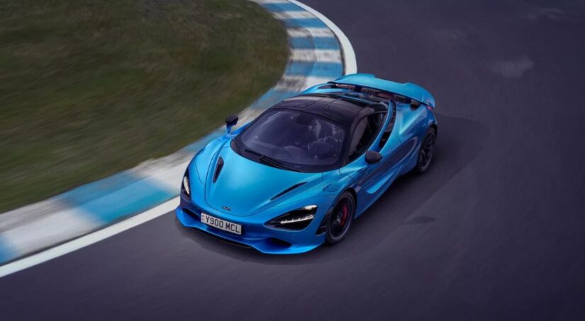 A blue 2024 McLaren 750S taking a corner on a racetrack