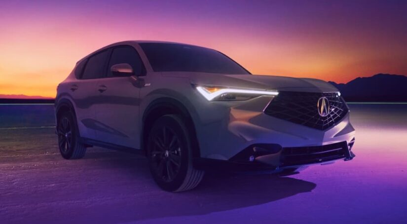 A gray 2025 Acura ADX parked off-road at night