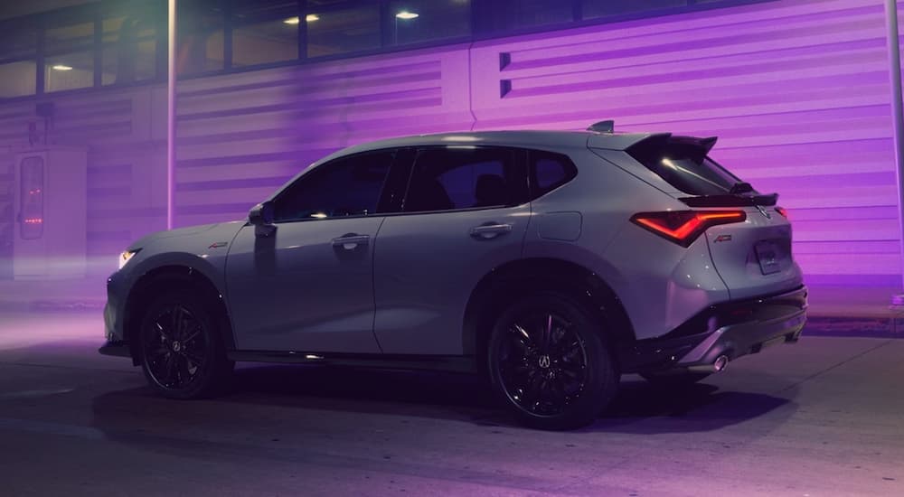 A gray 2025 Acura ADX driving in a city at night