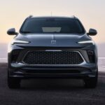 A silver 2026 Buick Encore GX for sale parked on a beach.