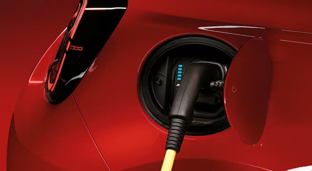 Close-up of a charge port on a red FIAT 500e.