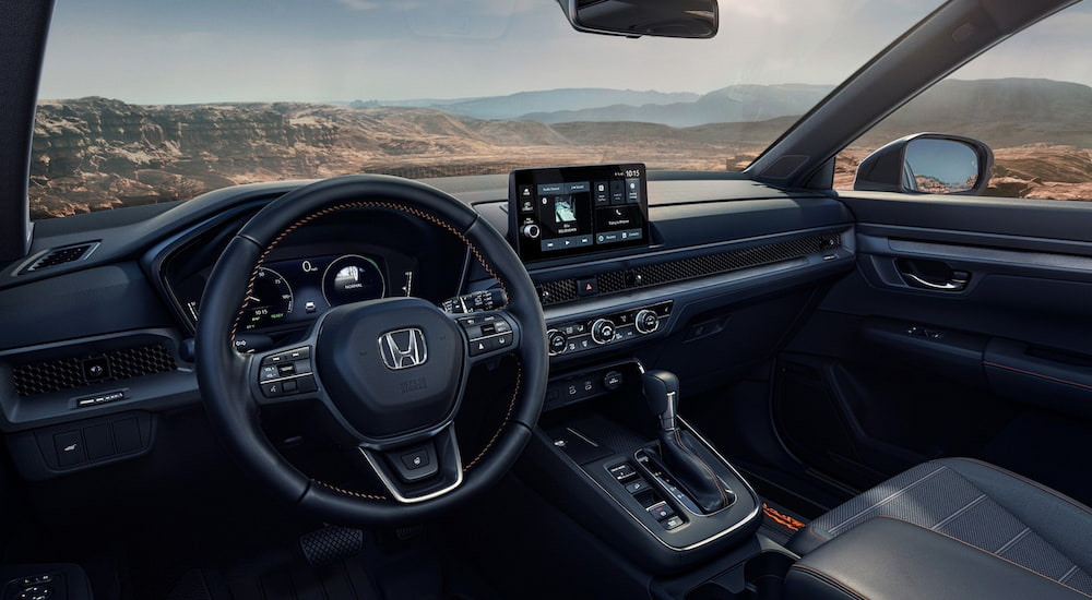 Steering wheel and dashboard inside a 2026 Honda CR-V.
