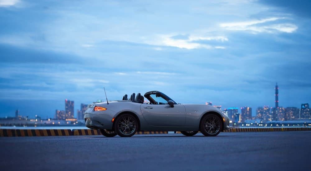 a white 2025 Mazda MX-5 Miata parked on a cloudy day.