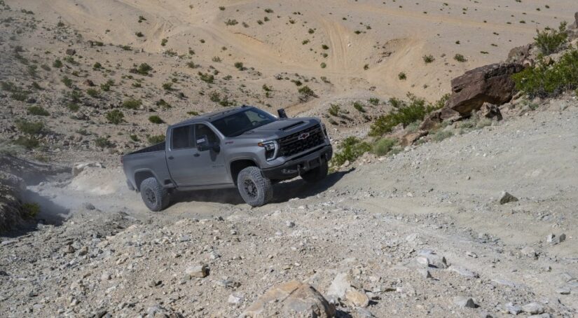 Grey 2025 Chevy Silverado 2500 HD ZR2 Bison driving up a hill