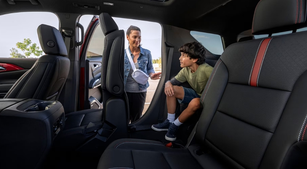 Child in the back seat of a 2026 Chevy Traverse for sale