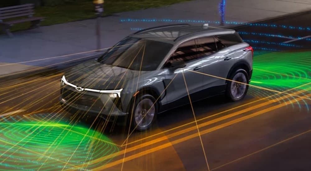 A gray 2024 Chevy Blazer EV with simulated safety lines.