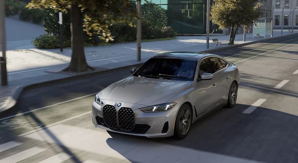 A gray 2026 BMW 4 Series Gran Coupe driving in a city.