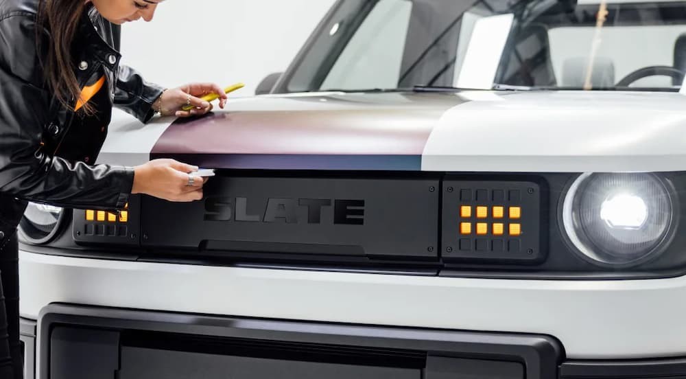 A white 2026 Slate Truck parked near a person.