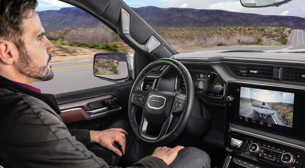 A person driving in a 2026 GMC Sierra 1500.