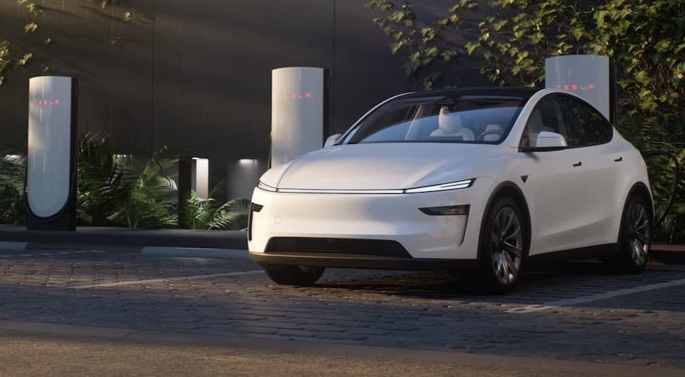 A white 2025 Tesla Model Y charging.