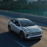 A gray 2026 Toyota C-HR driving on a bridge