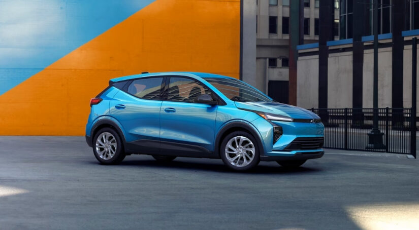 A blue 2027 Chevy Bolt LT parked off-road