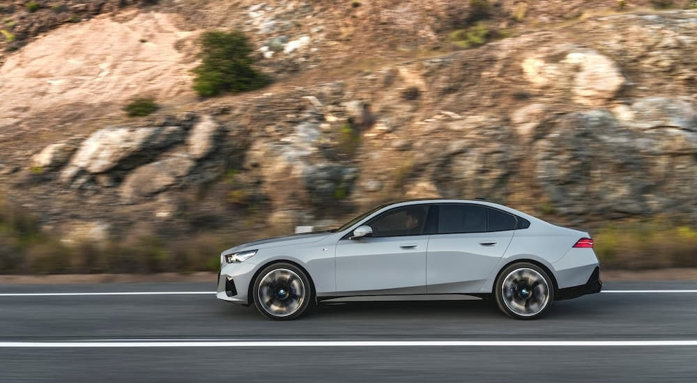 Grey 2024 BMW i5 from the side on an open road