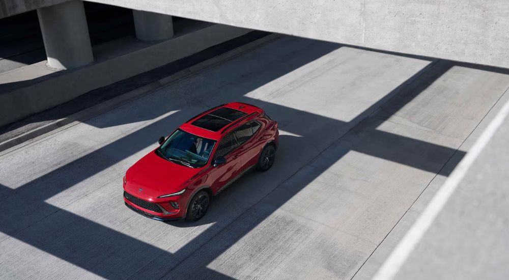 Aerial view of a red 2026 Buick Envision while driving on the freeway.
