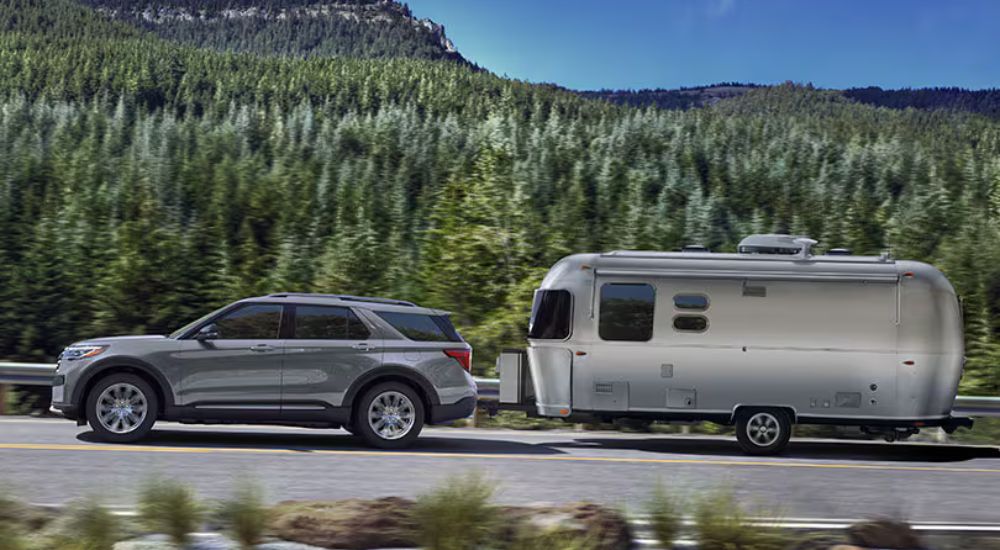 Grey 2026 Ford Explorer Tremor towing a camper.