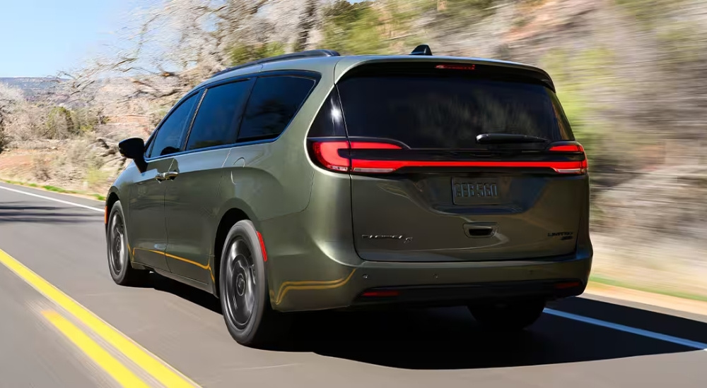 Green 2027 Chrysler Pacifica Limited driving on a highway