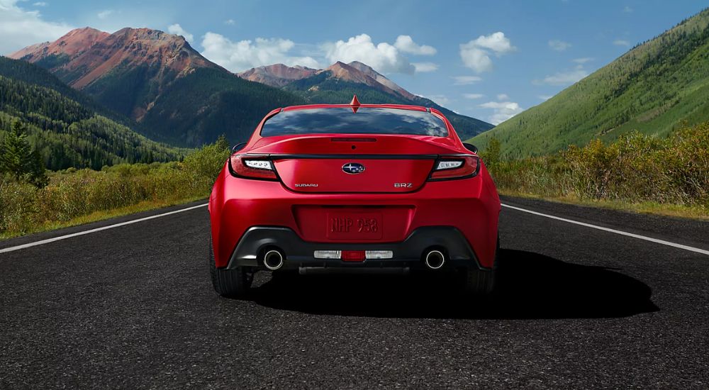 A red 2026 Subaru BRZ shown driving from rear.