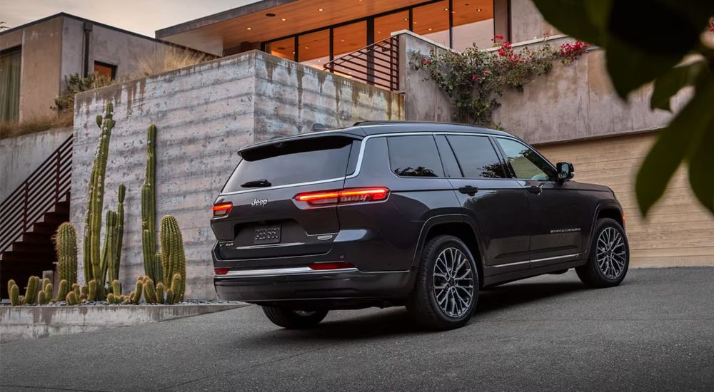 A black 2026 Jeep Grand Cherokee L Summit shown parked in a driveway.