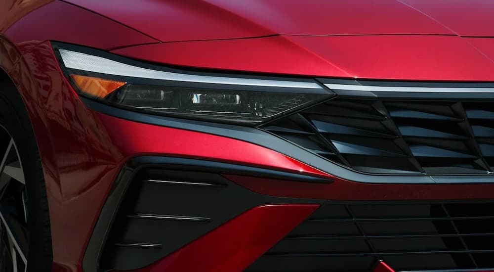 Headlight on a red 2025 Hyundai Elantra.