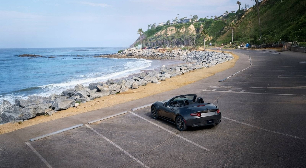 Grey 2026 Mazda MX-5 Miata parked on a coastal lot
