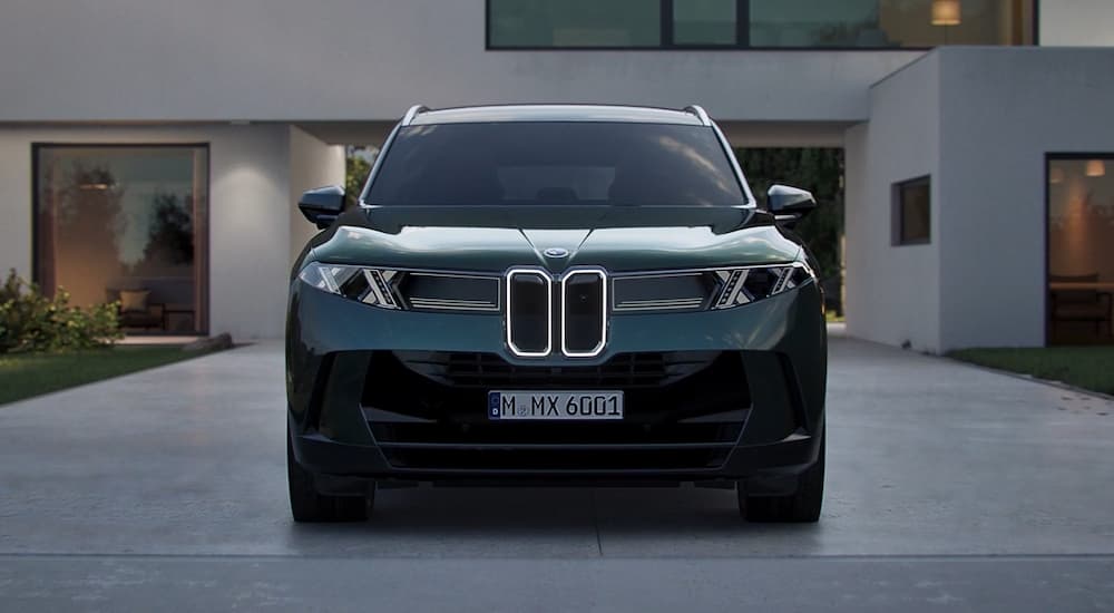 A black 2027 BMW X5 parked in a driveway