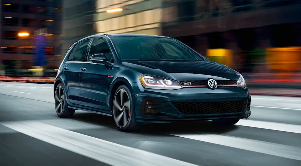 A black 2020 Volkswagen Golf GTI driving.